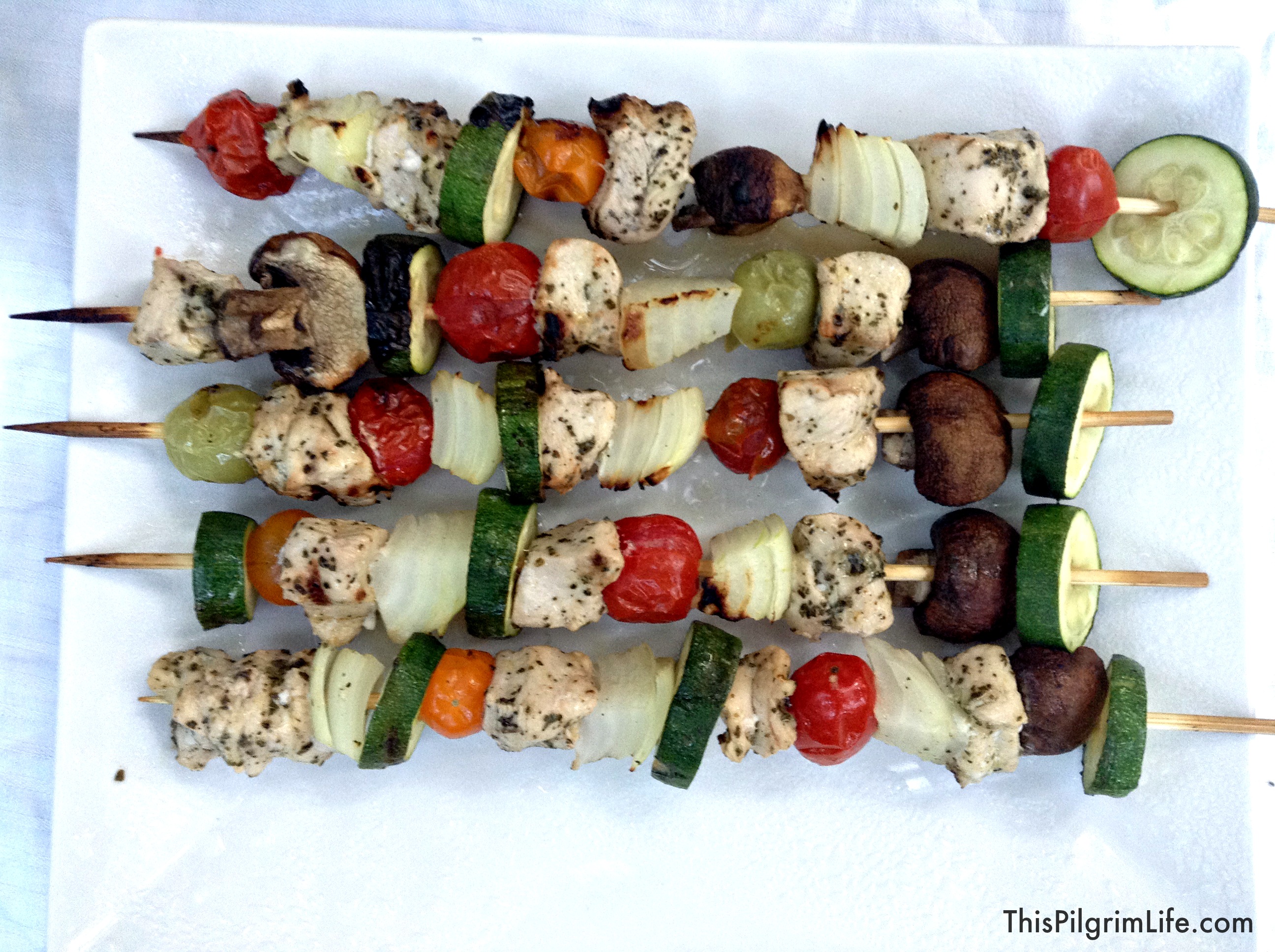 Copycat Zoe's Kitchen- An easy, at-home version of Zoe's grilled chicken kabobs, rice, and Greek salad. 