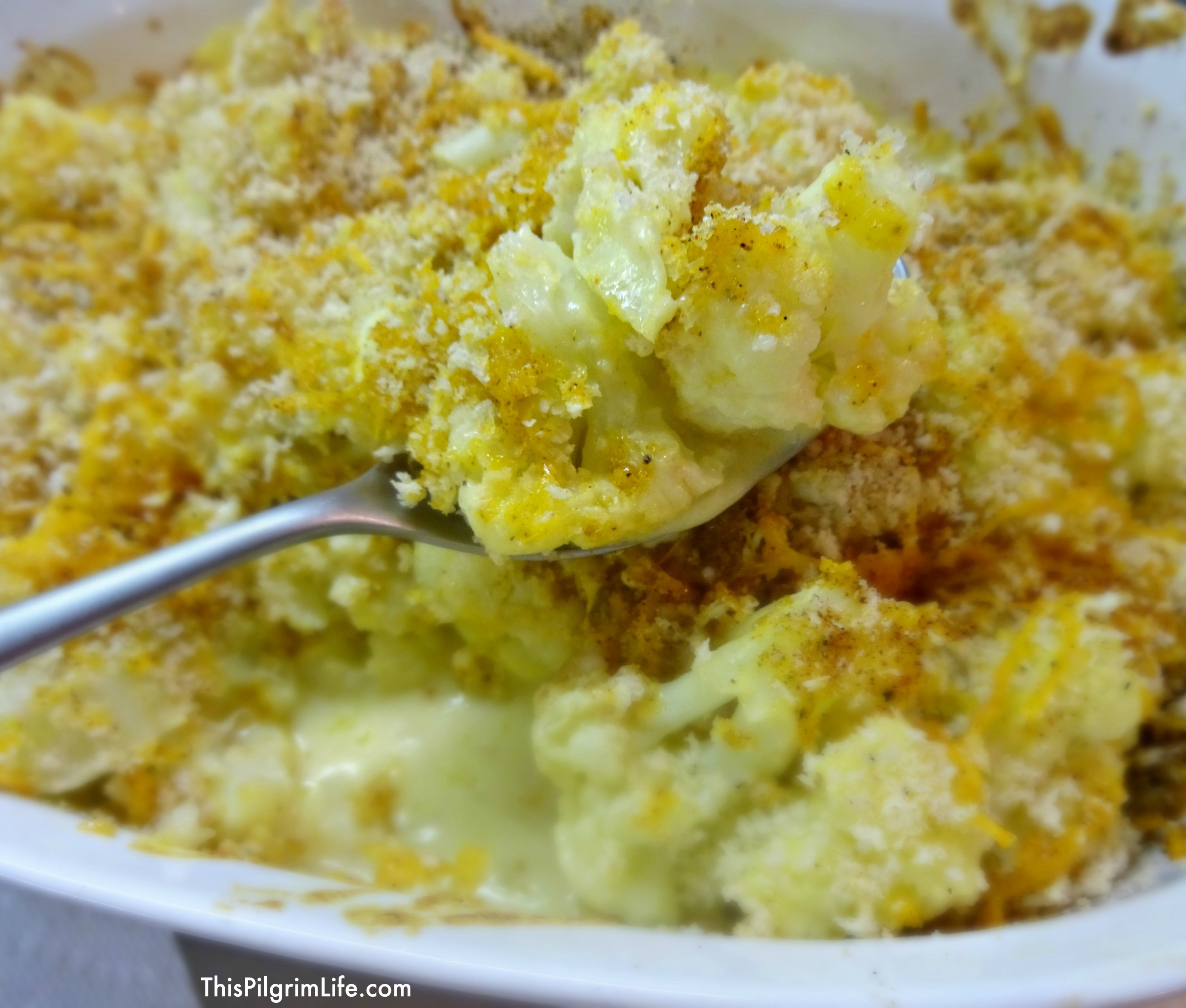 A comfort food side dish that is big on flavor, made with common kitchen ingredients :: healthy cauliflower tossed in a creamy sauce and topped with crunchy, cheesy goodness. 