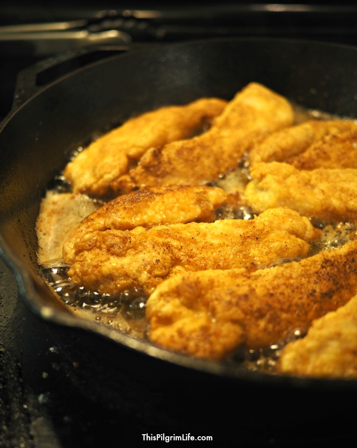 Pan fried chicken cooking in the skillet