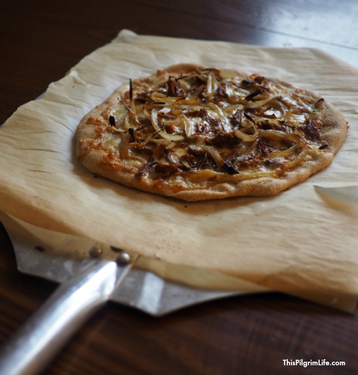Delicious homemade pizza topped with sweet onions and tangy barbecue chicken! 