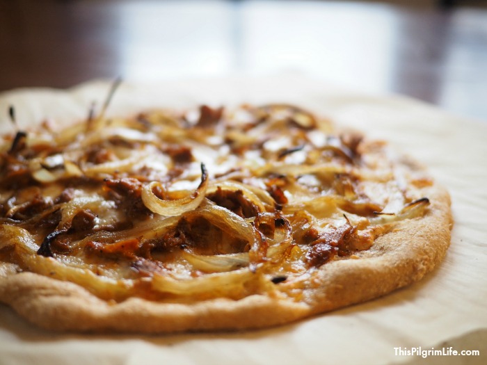 Delicious homemade pizza topped with sweet onions and tangy barbecue chicken! 