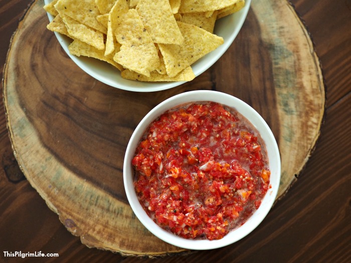 This homemade fresh salsa is seriously amazing! It's chunky and full of flavor-- and only takes about five minutes to make! We love this salsa on chips, nachos, tacos, quesadillas, soups, and more-- no wonder it doesn't last long!