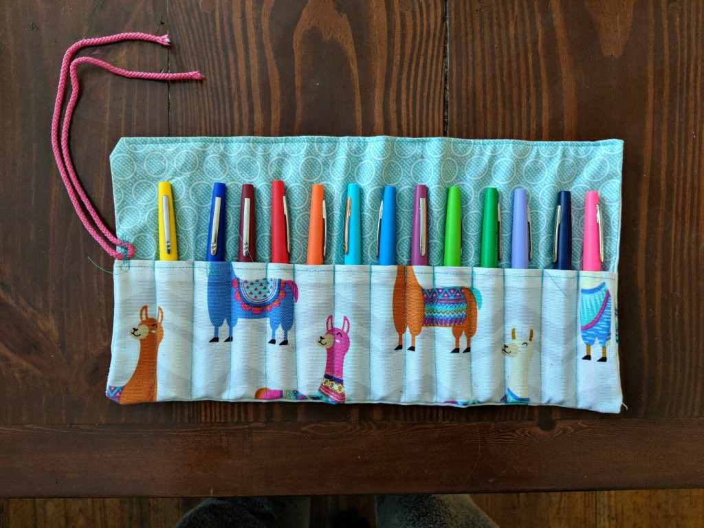 Keep pens, colored pencils, and crayons organized and easy to use with this pencil roll-up! Find both video and written instructions for this simple sewing project.