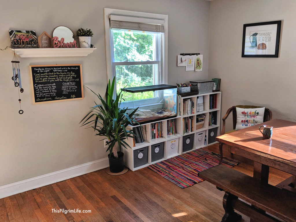 This is our current homeschool organization in our dining room. We have five kids and an average sized house, but everything is still neat, tidy, and inviting! Plus, check out a mega list of our favorite homeschool resources, and get a few free printables for your homeschool space! 