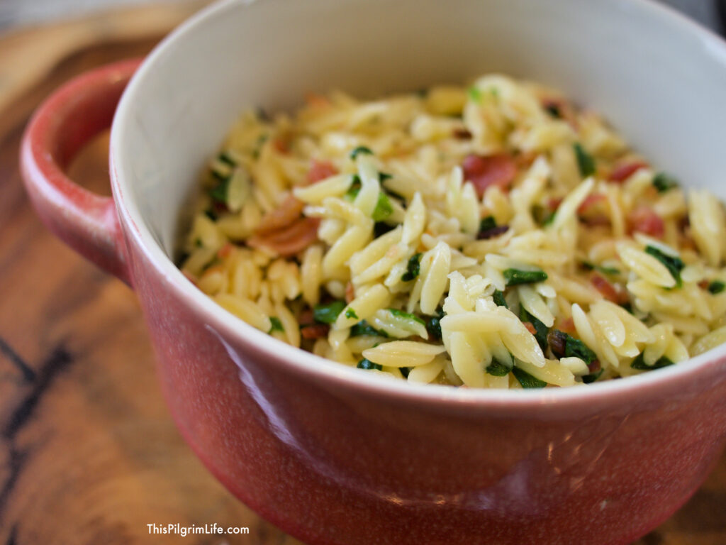 This garlic orzo is so easy in the Instant Pot! It's the perfect quick and easy lunch or comfort-food dinner. We love it with bacon and greens, but the variations are endless! 