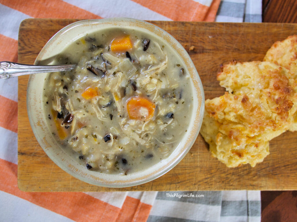 Instant Pot Chicken and Wild Rice soup is so easy to make-- just dump everything in the Instant Pot and cook-- and is so tasty too! The soup is perfect with its rich and creamy broth, fluffy rice, chicken, and vegetables. 