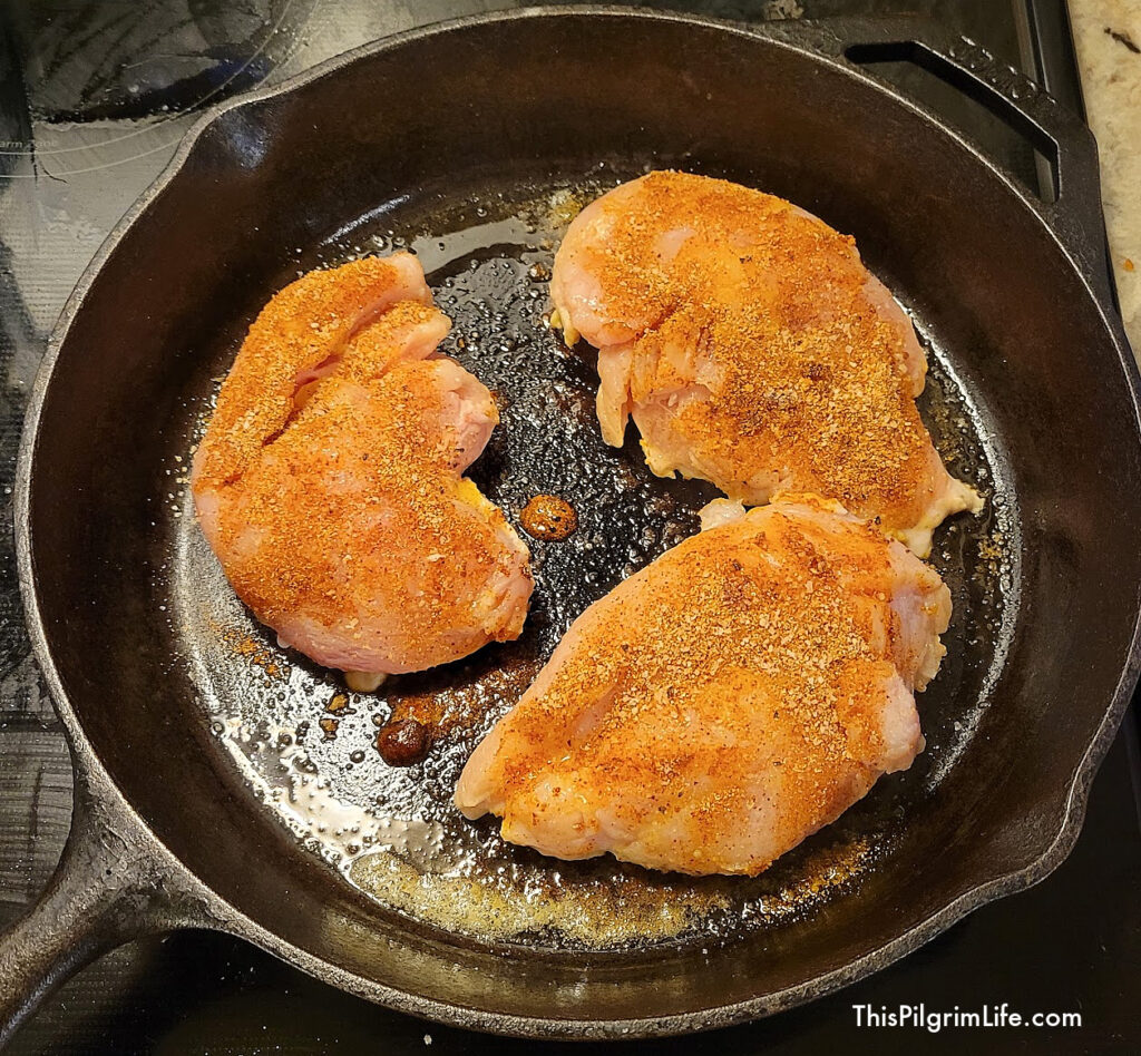 The blackened chicken starts by browning in the pan on each side. 